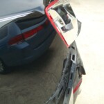 Before and after photographs of a damaged black Volkswagon Jetta that was repaired by Elite Paint & Body Shop in West Palm Beach, Florida.